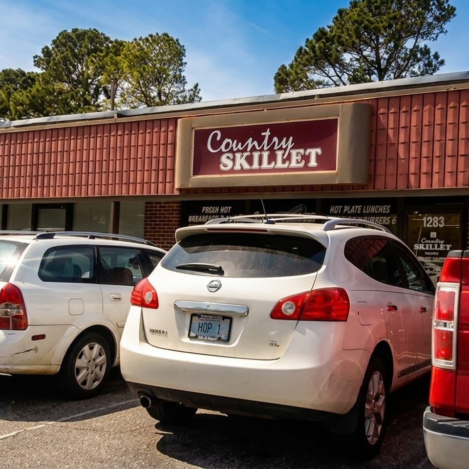 Exterior view of Country Skillet restaurant with cars parked in front.