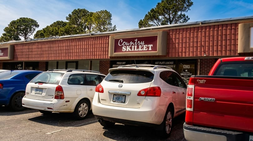 Exterior view of Country Skillet restaurant with cars parked in front.
